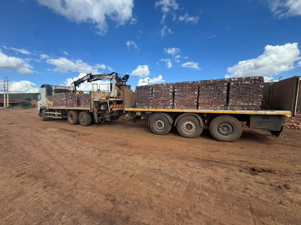 Brick lorry parked in the yard between loads for customers across Harare
